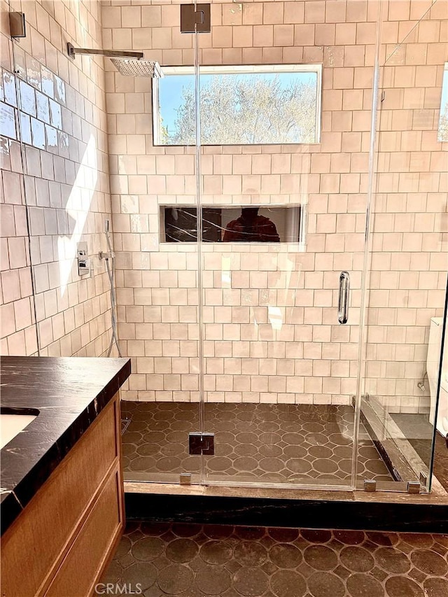 bathroom with a shower with door