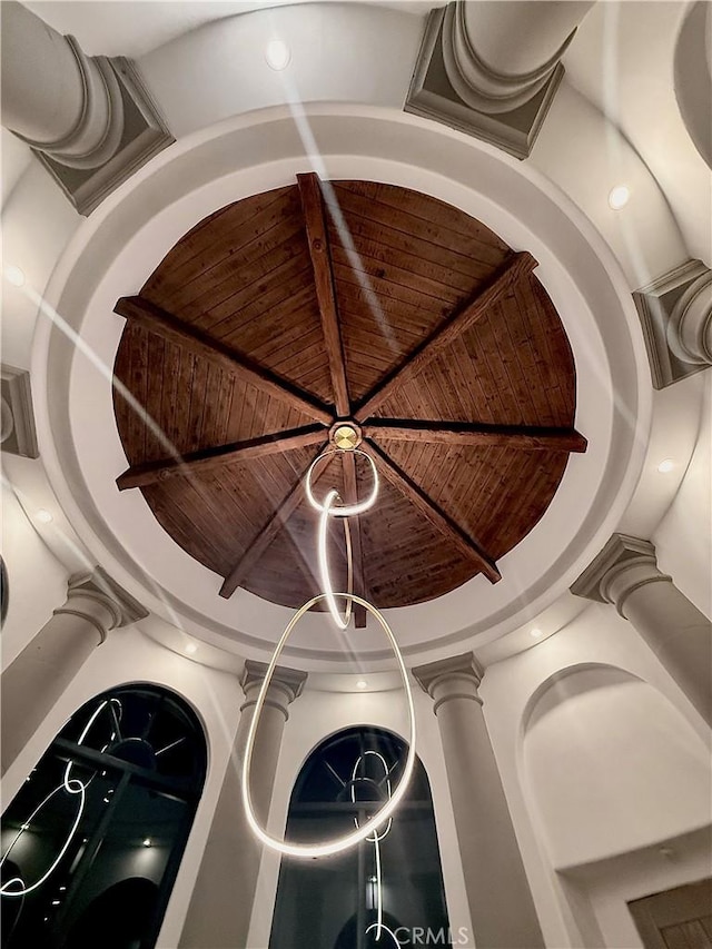 room details with wood ceiling, beamed ceiling, and decorative columns