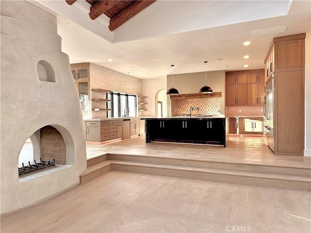 kitchen with built in fridge, a spacious island, decorative light fixtures, backsplash, and lofted ceiling with beams