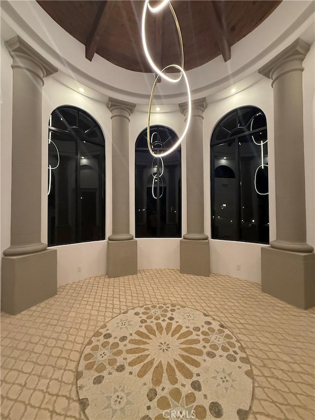 interior space with wood ceiling and decorative columns