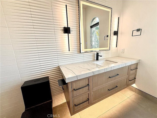 bathroom with tile patterned floors, tasteful backsplash, and vanity