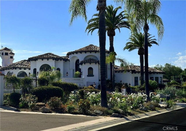 view of front of home with fence and stucco siding