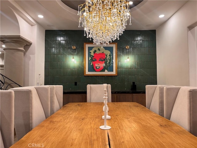 dining space featuring recessed lighting and decorative columns