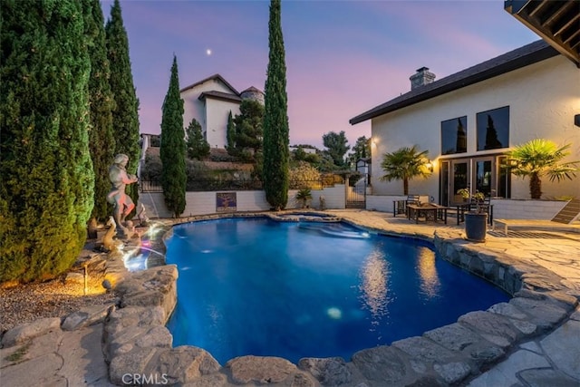 pool at dusk with a patio