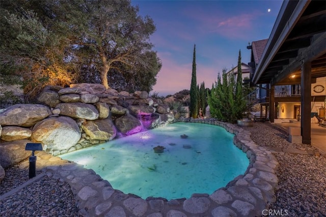 view of pool at dusk