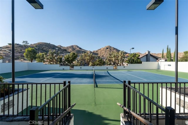 view of tennis court with a mountain view