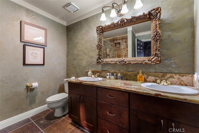 bathroom featuring toilet, vanity, and ornamental molding