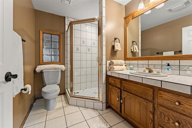 bathroom with toilet, tile patterned flooring, walk in shower, and vanity