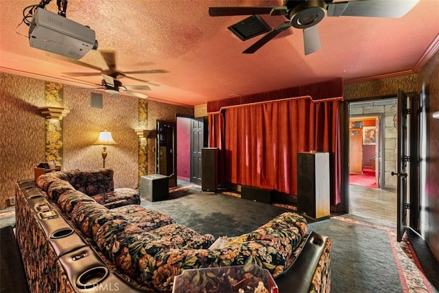 cinema room featuring a textured ceiling, crown molding, and dark carpet