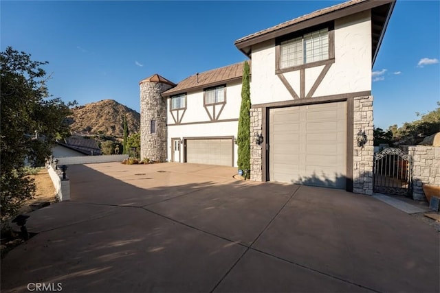 view of front of home with a garage and a mountain view