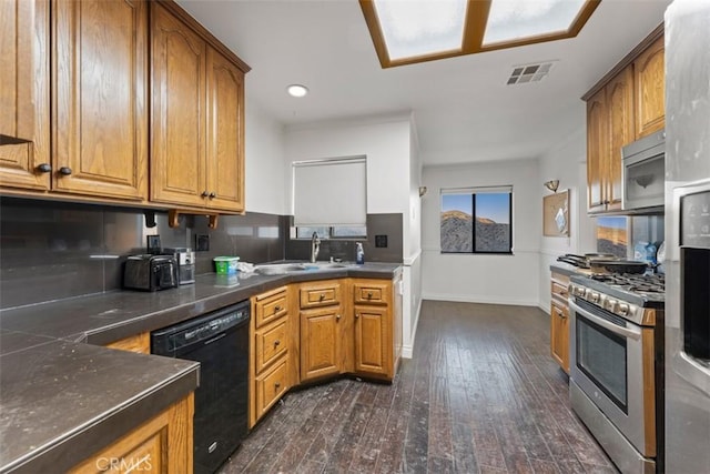 kitchen featuring decorative backsplash, sink, dark hardwood / wood-style flooring, and stainless steel appliances