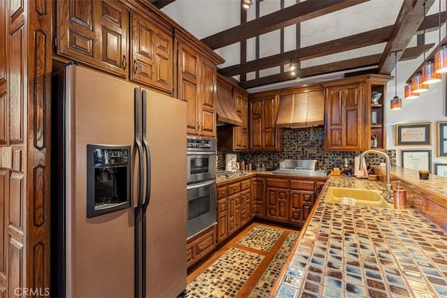 kitchen featuring tile countertops, custom exhaust hood, stainless steel appliances, beam ceiling, and sink