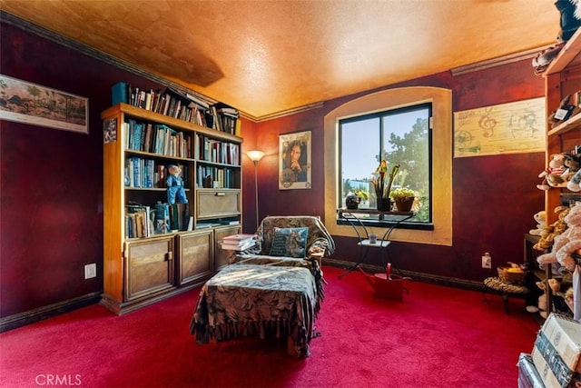 sitting room with ornamental molding and carpet flooring