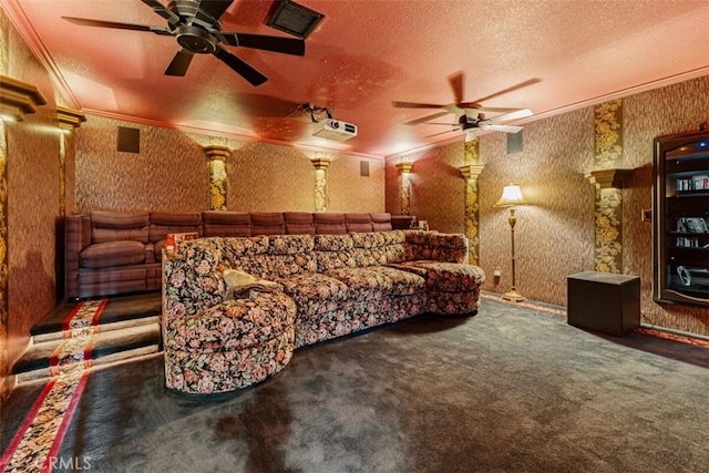 home theater with decorative columns, dark carpet, crown molding, and a textured ceiling