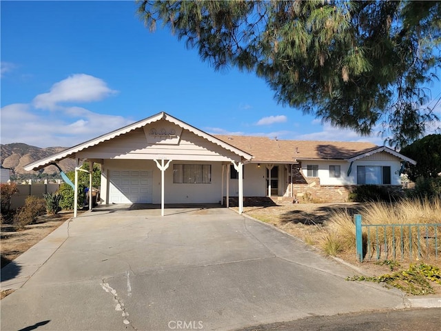 ranch-style home with a garage and a carport