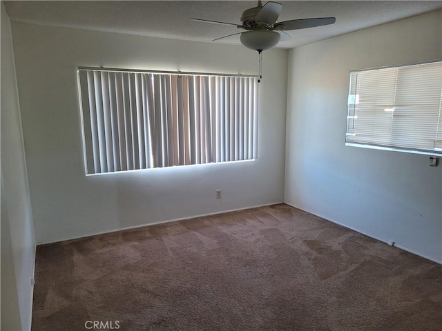 carpeted empty room featuring ceiling fan