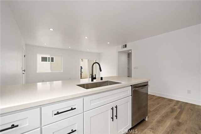 kitchen featuring sink, white cabinetry, dishwasher, and light hardwood / wood-style flooring