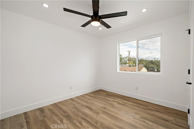 empty room featuring ceiling fan and hardwood / wood-style floors