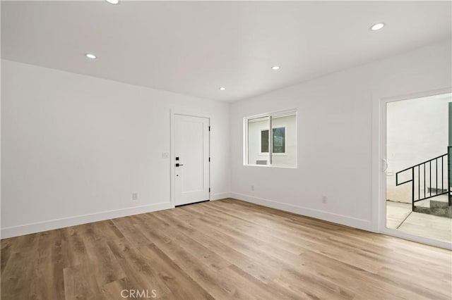 spare room featuring light hardwood / wood-style floors