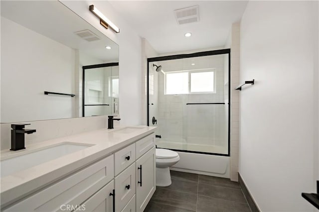 full bathroom with toilet, bath / shower combo with glass door, and vanity