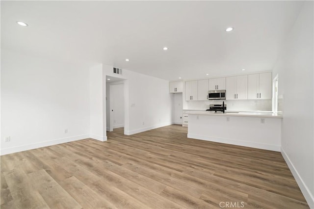 unfurnished living room featuring light wood-type flooring