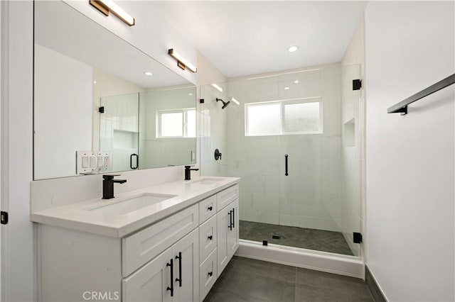 bathroom with a shower with door and vanity