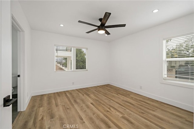 spare room featuring ceiling fan and light wood-type flooring