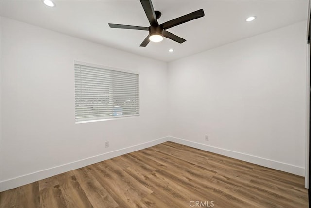 empty room featuring ceiling fan and hardwood / wood-style floors