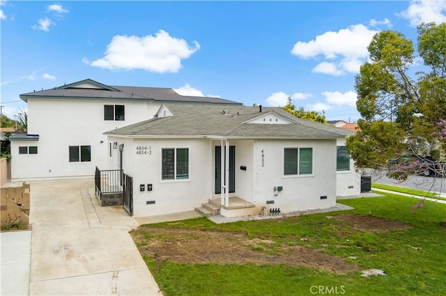 view of front of home with a front yard and central air condition unit