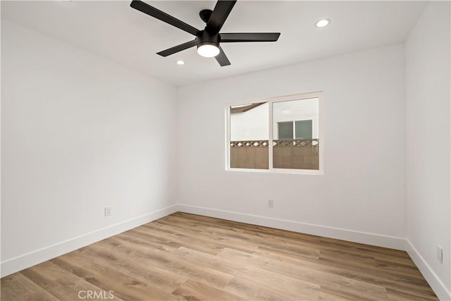 empty room with ceiling fan and light hardwood / wood-style floors