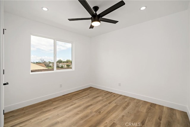 spare room featuring ceiling fan and light hardwood / wood-style floors