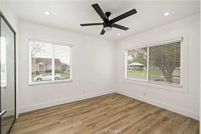 unfurnished room featuring ceiling fan and light wood-type flooring