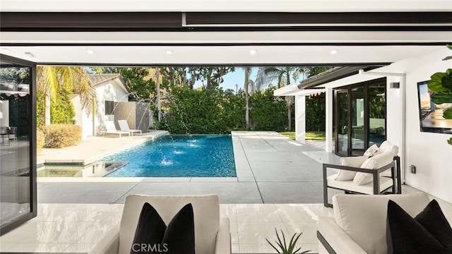 view of swimming pool featuring pool water feature, a patio area, and a hot tub