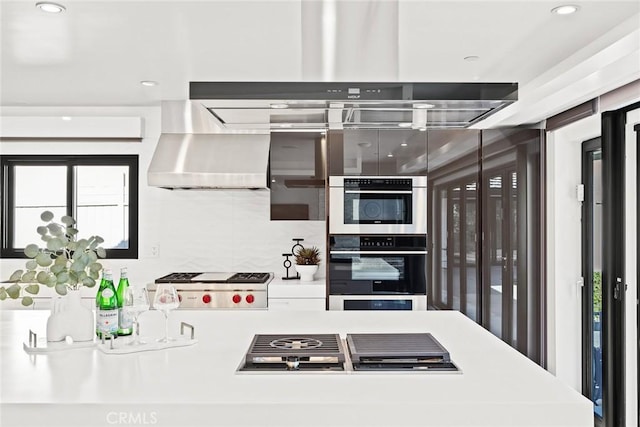 kitchen featuring stainless steel appliances and wall chimney exhaust hood