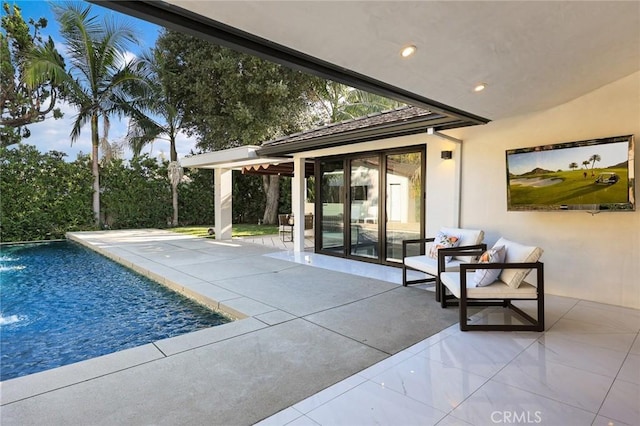 view of pool with pool water feature and a patio