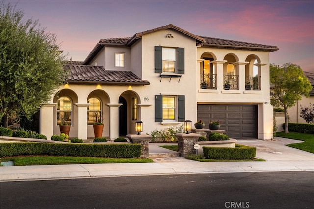 mediterranean / spanish house with a garage