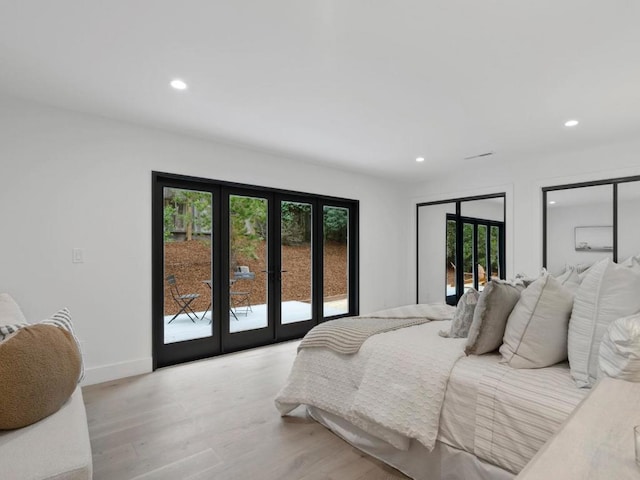 bedroom with access to exterior, french doors, and light wood-type flooring