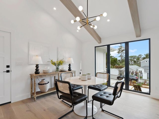 dining space with light wood-type flooring, beamed ceiling, high vaulted ceiling, and a notable chandelier