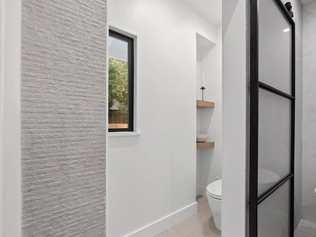 bathroom with toilet, an enclosed shower, and tile patterned floors