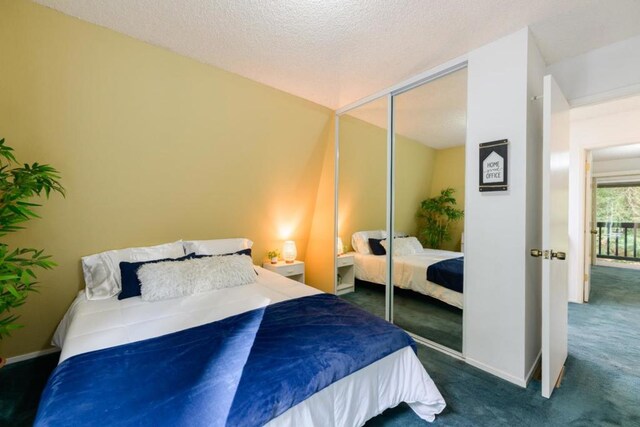 bedroom with dark carpet, a closet, and a textured ceiling