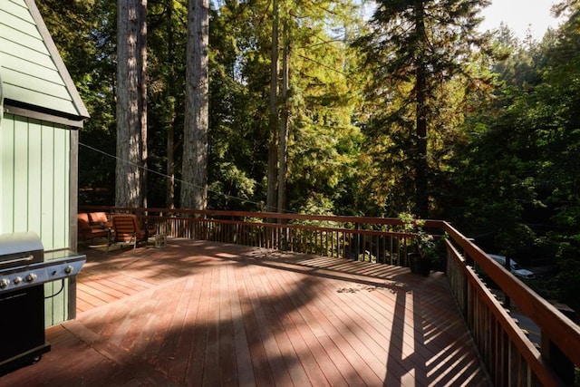 wooden deck featuring a grill