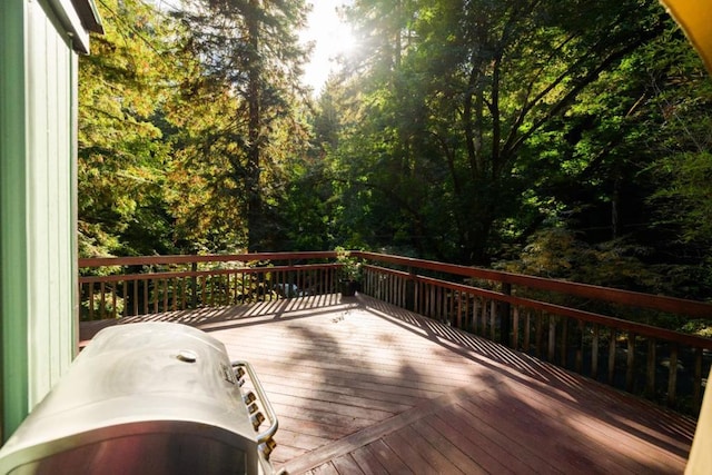 wooden terrace featuring a grill