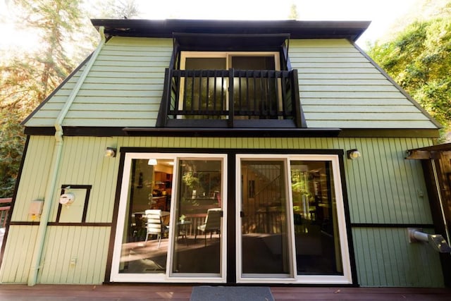 back of house featuring a wooden deck