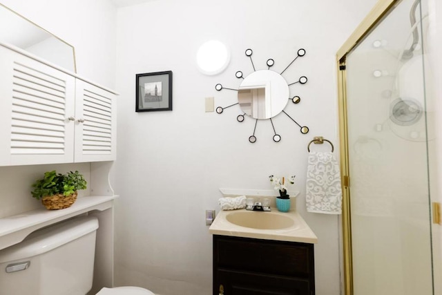 bathroom with a shower with door, toilet, and vanity