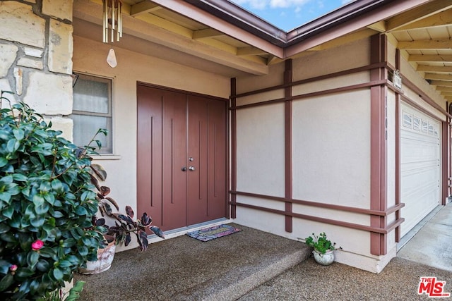 view of exterior entry with a garage