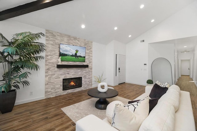 living room featuring beam ceiling, a fireplace, high vaulted ceiling, and dark hardwood / wood-style floors