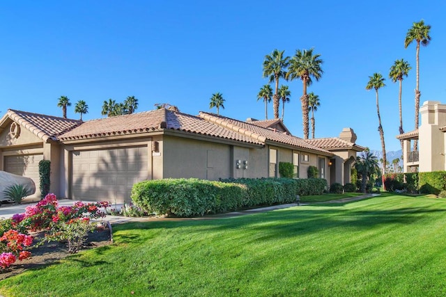 view of front of home featuring a garage and a front yard