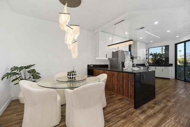 dining room featuring dark hardwood / wood-style floors and beam ceiling