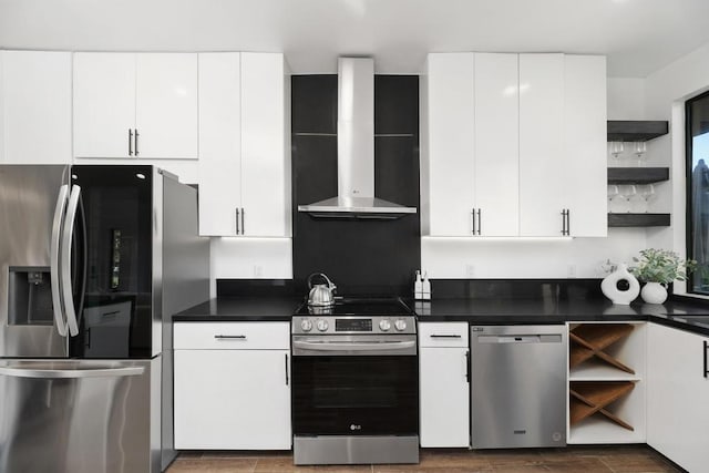 kitchen with white cabinetry, wall chimney range hood, and appliances with stainless steel finishes