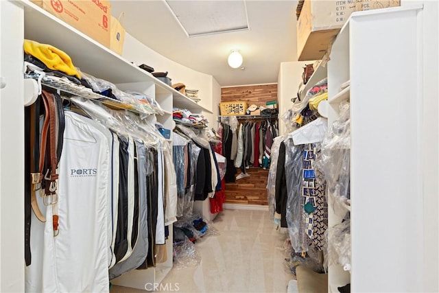 walk in closet featuring light carpet